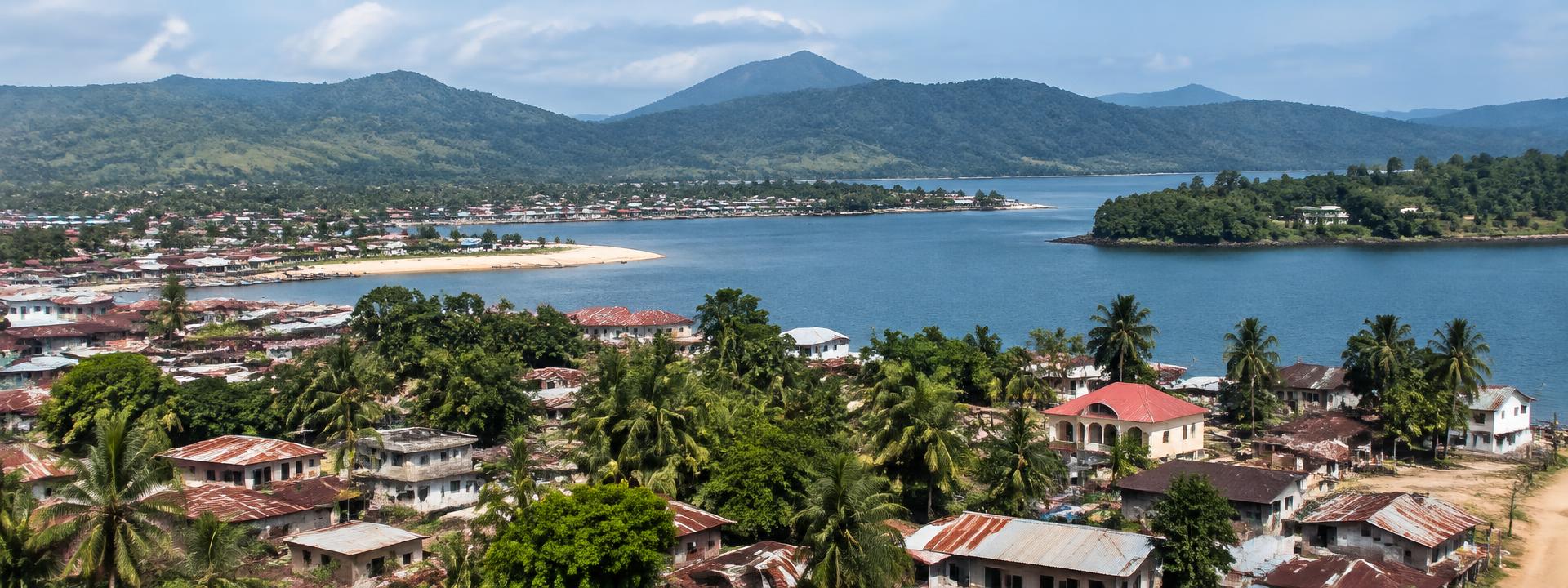 Coastal Liberian town with palm trees and hills